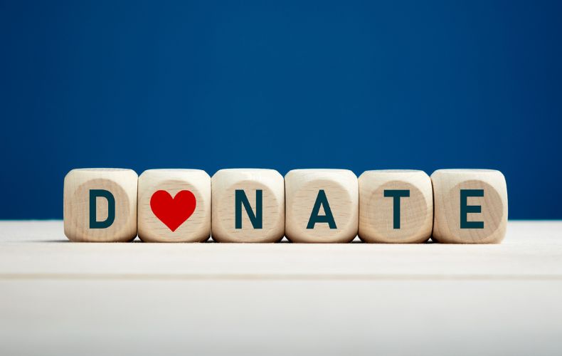 the word donate is written on wooden blocks